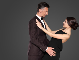 Happy mature couple on dark background