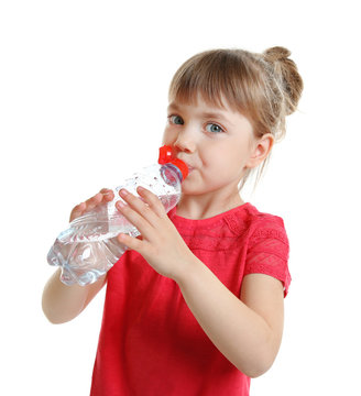 Beautiful small girl drinking water, isolated on white