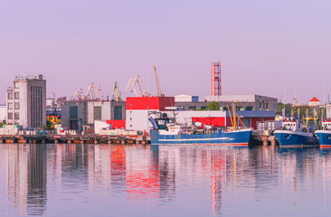 Vessels and cranes at the Marina in Ventspils at sundown