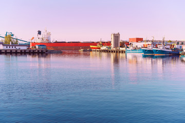 Vessels and cranes at Marina in Ventspils at sundown