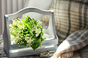 Bouquet of fresh spring flowers on chair indoors