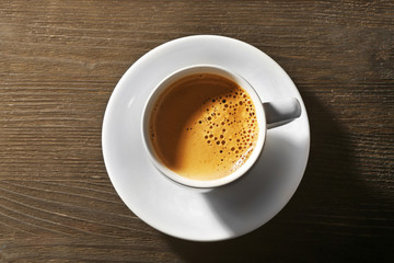 Cup of fresh coffee on wooden background
