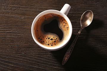 Cup of fresh coffee on wooden background