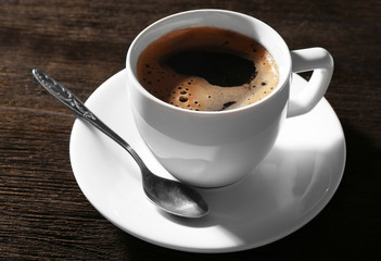 Cup of fresh coffee on wooden background