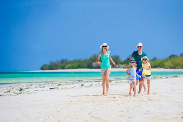 Happy family of four on the beach