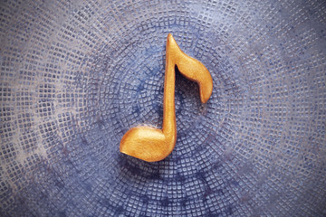 Music note on metal background