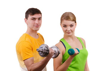 Couple exercising with dumbbells lifting weights