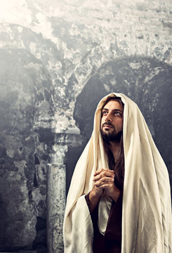 Jesus Christ prays with clasped hands