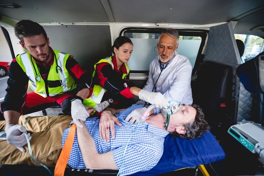 Injured man with ambulance men