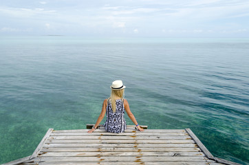 Young woman relax on the dock in Cayo Guillermo, Cuba.