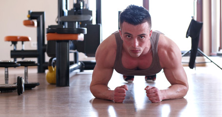 Portrait of a handsome man doing push ups exercise
