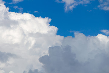 Blue sky with stormy fluffy clouds