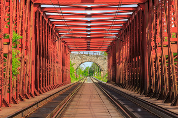 Railroad on a red bridge in summer day