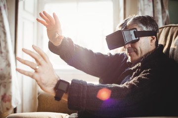 Side view of man using smart glasses while sitting