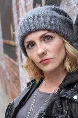 Portrait angry blonde woman on urban cool background