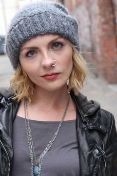 Beautiful urban girl wearing beanie and a popular nose ring 