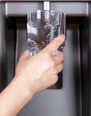 Poster Drinking glass being filled up with filtered clean water © tab62