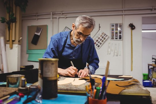 Cobbler working in workshop