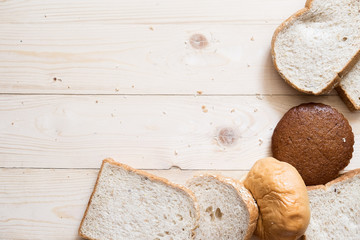 Top view of Assortment of baked bread on wooden table background with copy space
