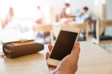 Close up of a young man using mobile smart phone focus on her hand with mining light