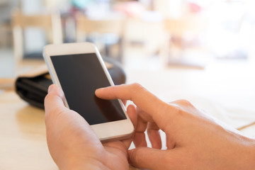 Close up of a young man using mobile smart phone focus on her hand with mining light
