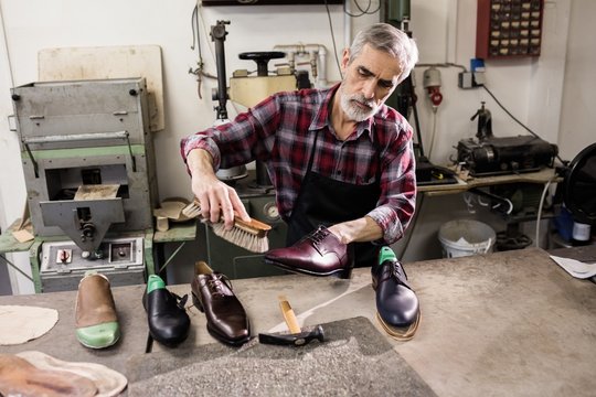 High angle view of cobbler polishing a shoe