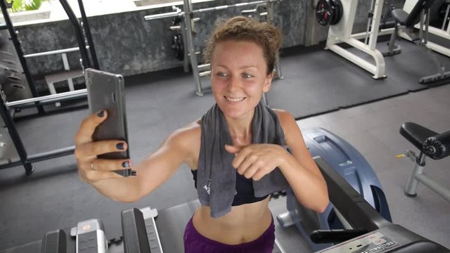 Sporty Young Woman Taking a Selfie in Gym During Workout.