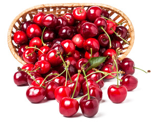 cherries in a wicker basket isolated on white background