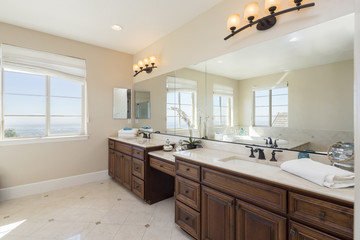 Fototapeta na wymiar Luxury bathroom with marble tiles and oval bathtub with view window.