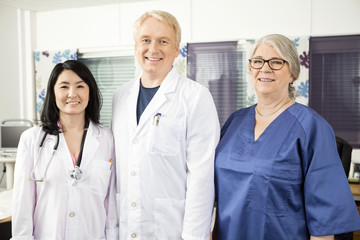 Fototapeta premium Confident Medical Team Standing Together In Clinic