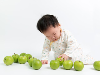Fototapeta premium Asian baby with green apples