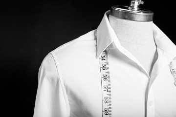 Shirt on manikin with white measurement tape