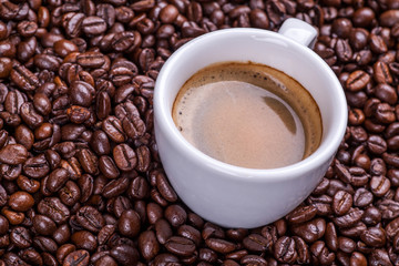 Cup on coffee beans
