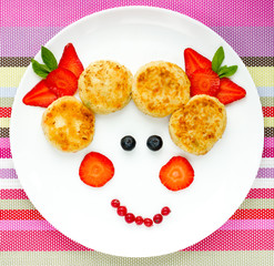 Creative idea for baby breakfast - cheese pancakes with berries