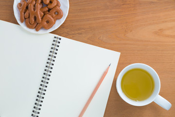 Blank notebook, pencil, drink, snack