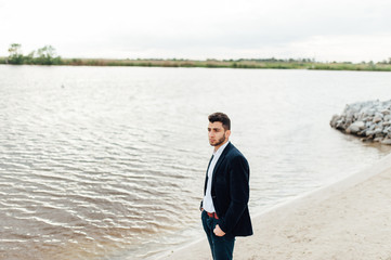 groom portrait near the boat at a wedding day