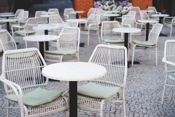 Cozy outdoor cafe with cane chairs