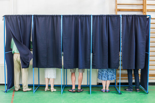 People voting in booths
