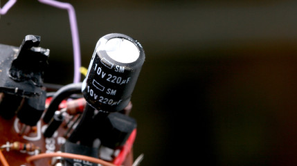 Part of old vintage printed circuit board with electronic components.