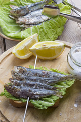 Sandwich with sardines, sprats with parsley and dill