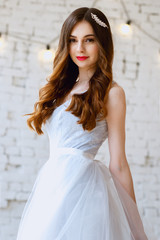 Fototapeta premium Bride in a tender light blue wedding dress in a morning. Fashion beauty portrait