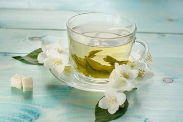Jasmine tea with jasmine herb flower on wooden table background. 
