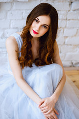 Fototapeta premium Bride in a tender light blue wedding dress in a morning. Fashion beauty portrait
