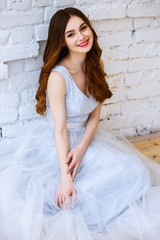 Fototapeta premium Bride in a tender light blue wedding dress in a morning. Fashion beauty portrait