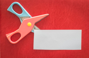 Scissors and paper on red background