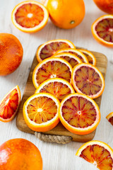cut blood oranges on wooden surface