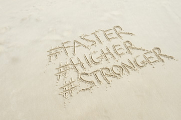 Faster, Higher, Stronger message modernized with social media hashtags in the sand