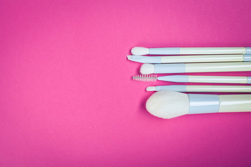 Set of colorful cosmetics on pink table