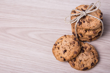 top view of freshly baked chocolate chip cookies on wooden backg