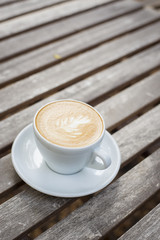 cappuccino cup on wood background
